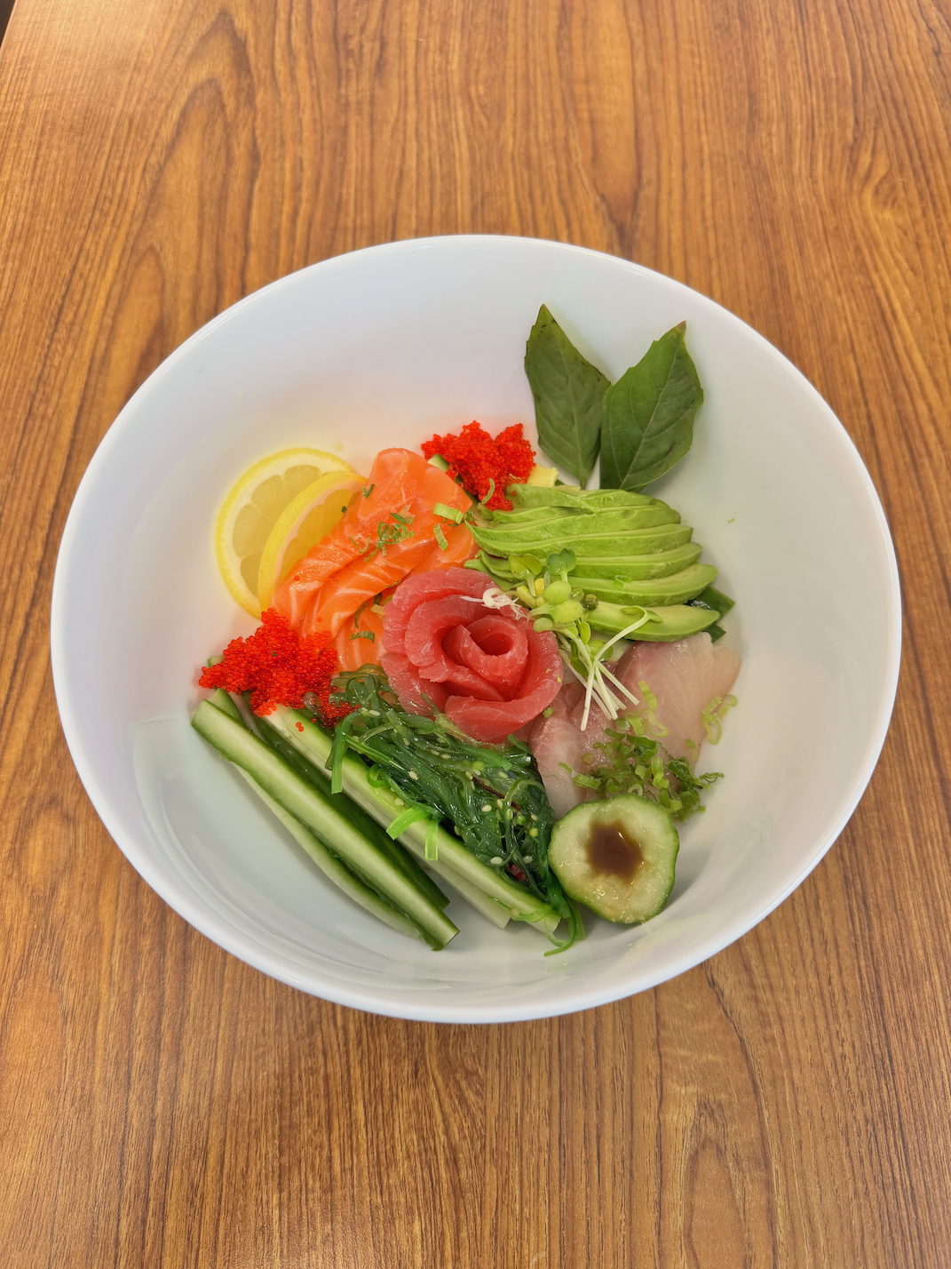 Chef preparing sushi rolls with eel sauce at Hikari Sushi